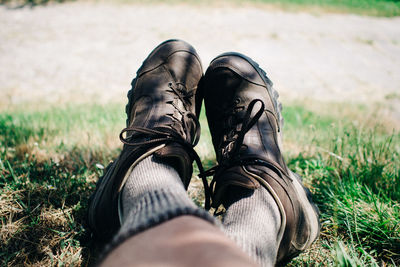 Low section of man resting on grassy field