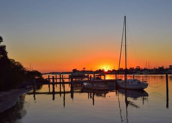 Sailboat at harbor at sunset