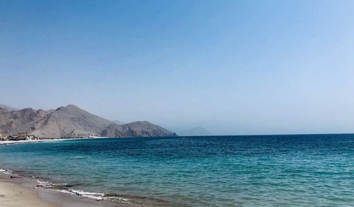 Scenic view of sea against clear blue sky