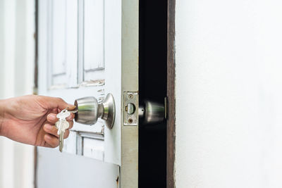 Midsection of person holding door