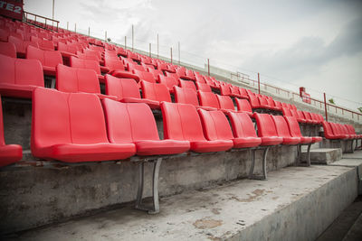 View of empty chairs in stadium against sky