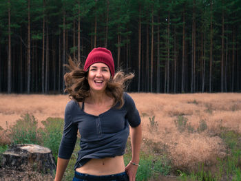 Portrait of smiling woman in forest