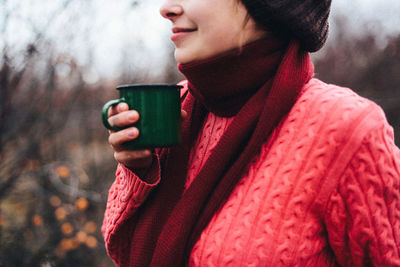 Close-up of woman drinking water in winter