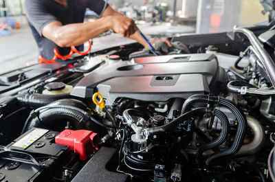 Midsection of man repairing car