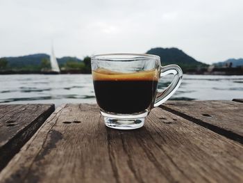 Close-up of drink on table against sky