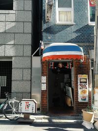 Bicycle on footpath by buildings in city