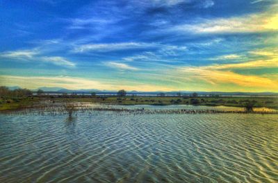 Scenic view of sea against cloudy sky