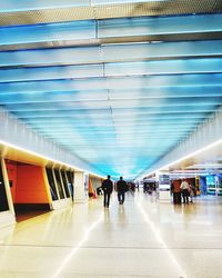 People walking in corridor of airport