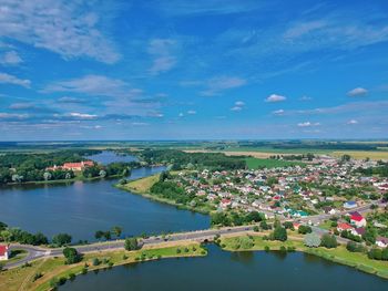 High angle view of river by cityscape against sky