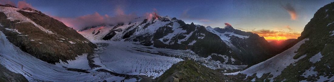 Panoramic view of mountains against sky during winter