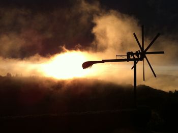 Silhouette of wind turbines at night