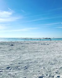 Scenic view of beach against blue sky