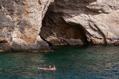 Heterosexual couple relaxing in sea