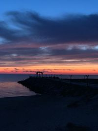 Scenic view of beach against sky during sunset