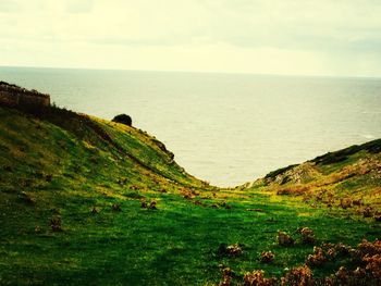 Scenic view of sea against cloudy sky