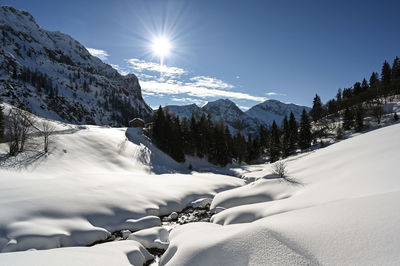 Scenic view of snow covered mountains against sky