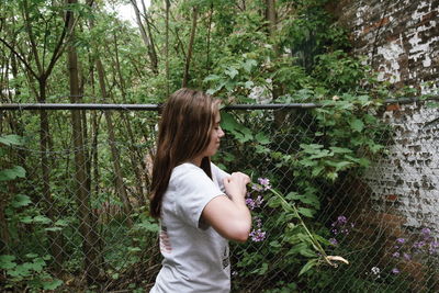 Side view of woman exercising in yard