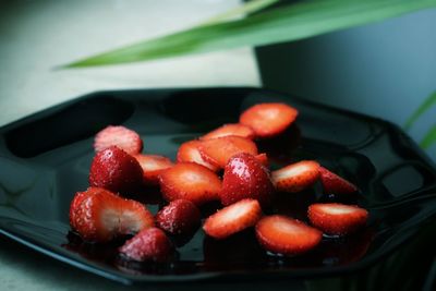 Close-up of chopped fruits in bowl on table