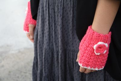 Midsection of woman with pink hair standing on hand