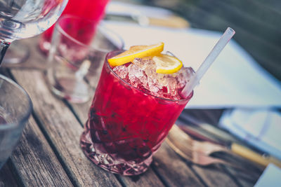 Close-up of crushed ice in cocktail glass on wooden table