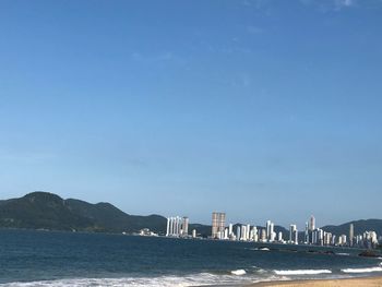 Scenic view of sea against clear blue sky