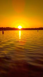 Scenic view of lake against romantic sky at sunset