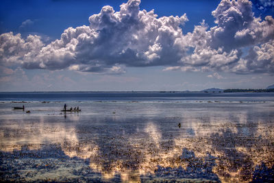 Scenic view of sea against blue sky