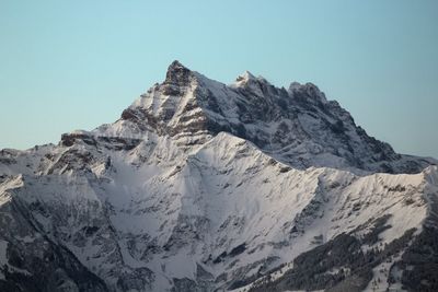 Scenic view of snowcapped mountains against clear sky