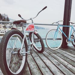 Bicycles on pier against sky