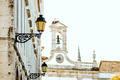 Low angle view of clock tower against sky in city