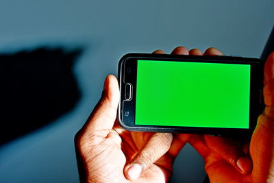 Close-up of hand holding mobile phone