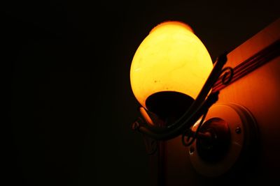 Close-up of illuminated lamp against black background