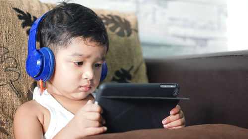 Portrait of boy using mobile phone