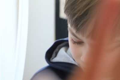 Close-up portrait of cute boy at home