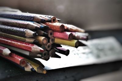 Close-up of wet colored pencils on table