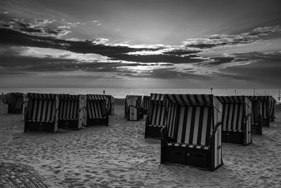 Pier over sea against sky during sunset