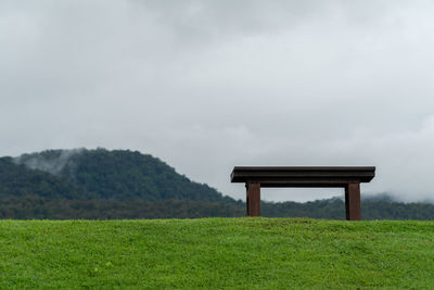 Built structure on field against sky