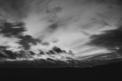 Low angle view of silhouette trees against sky