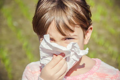 Close-up of girl blowing dandelion