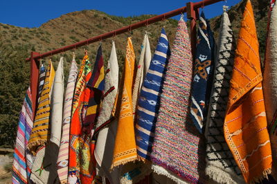 Multi colored clothes hanging at market stall