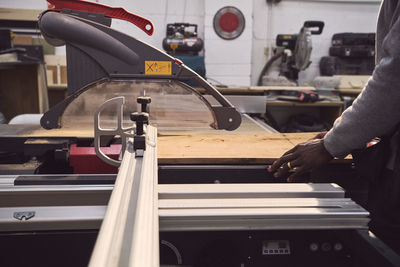 Midsection of carpenter working at workshop