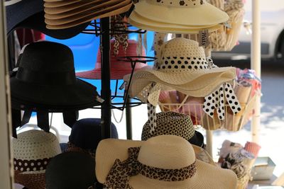 Close-up of hats hanging in store for sale