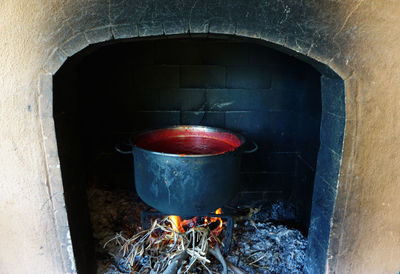Traditional tomato paste production in the fireplace
