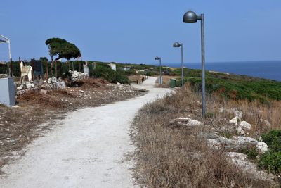 Street by road against sky