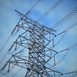 Low angle view of electricity pylon against sky