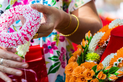 Midsection of woman holding flower bouquet