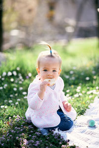 Portrait of cute girl sitting outdoors