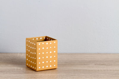 An empty decoration box on a wooden surface over white background