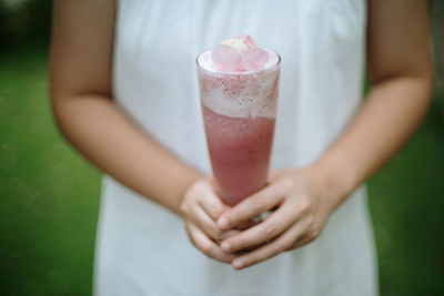 Midsection of woman holding ice cream