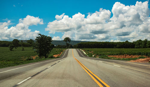 Road passing through landscape against sky